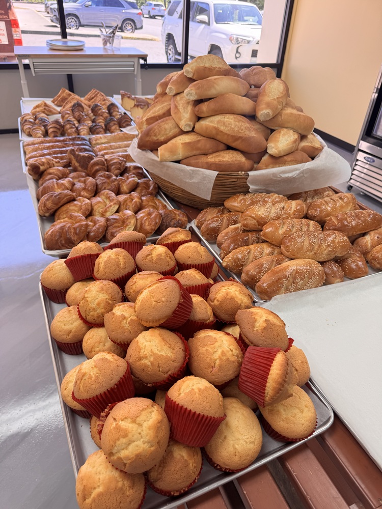 Close-up of a round flan with a glossy caramel topping and caramel sauce pooled around it.